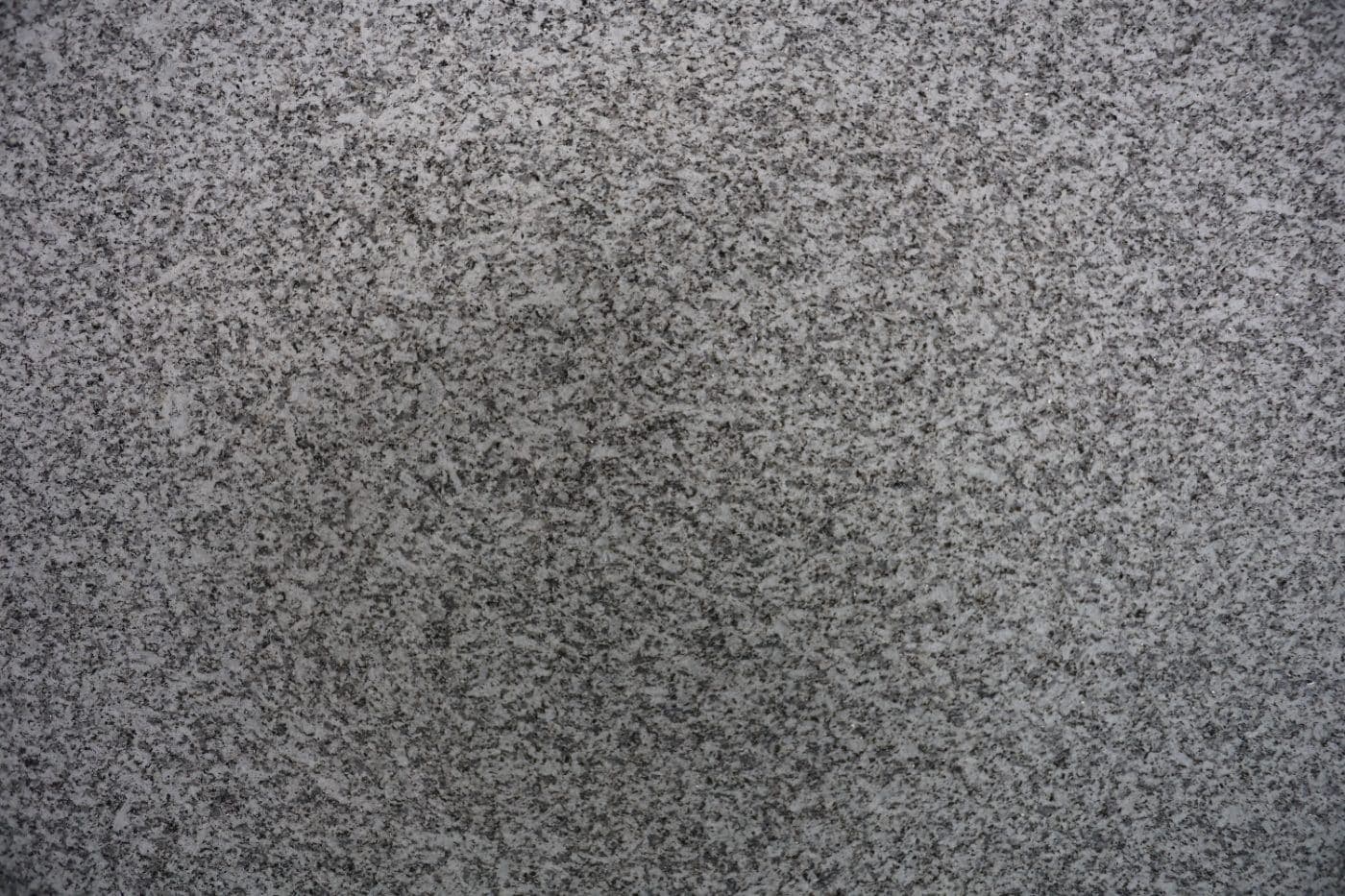 De Lank Cornish granite flame textured finish — An intense flame causes the surface crystals to micro-fracture and spall, leavin